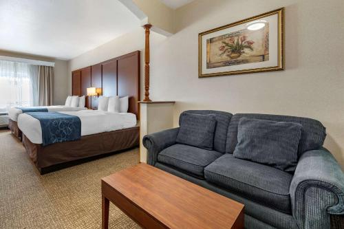 a hotel room with a bed and a couch at Comfort Suites in Redlands