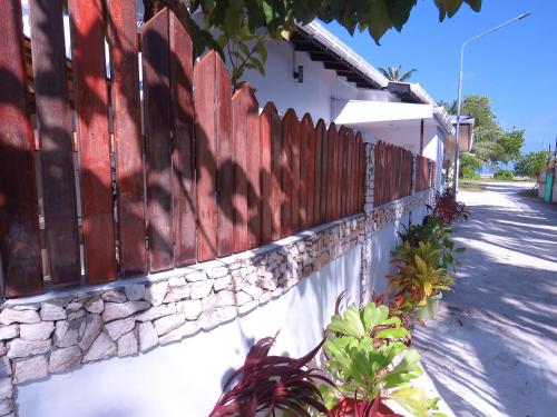 a fence on the side of a house at The Sunrise Huraa in Huraa