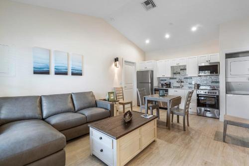 a living room with a couch and a table at Bermuda Bungalows (Tropical Island Getaway) in West Palm Beach