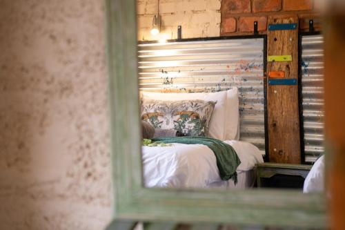 a reflection of a bed in a mirror at Otavi Vineyards Self-Catering & Camping in Otavi