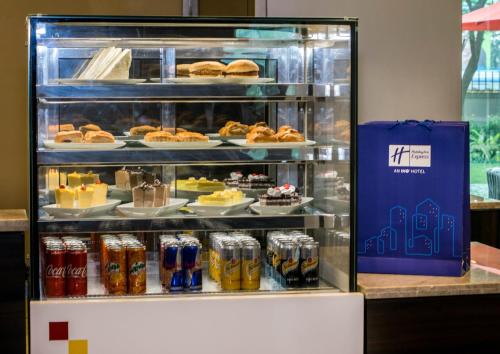 a display case filled with different types of drinks at Holiday Inn Express Kolkata Airport by IHG in Kolkata