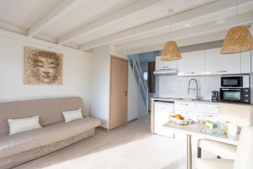 a living room with a couch and a table at Appartement Marineland Sea View in Antibes