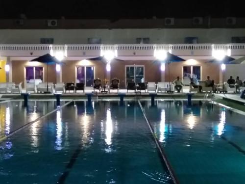 a pool at night in a hotel at Jewel El Gameel Hotel in Port Said