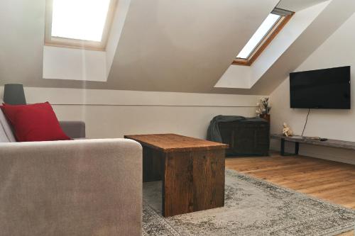 a living room with a couch and a flat screen tv at Apartmán NEWSTALGIE in Mikulov