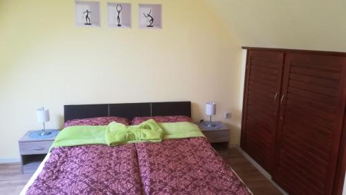 a bedroom with a bed with a yellow bow on it at MA-JA 4 in Bük