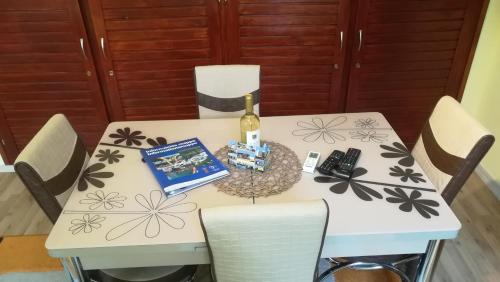 a table with a bottle of wine and a book at MA-JA 4 in Bük