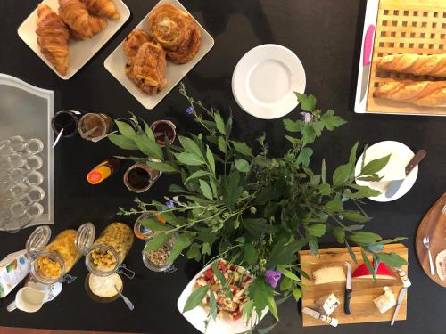 einem Tisch mit Lebensmittelplatten und einer Pflanze darauf in der Unterkunft Château Destinée in Saint-Seurin-de-Prats