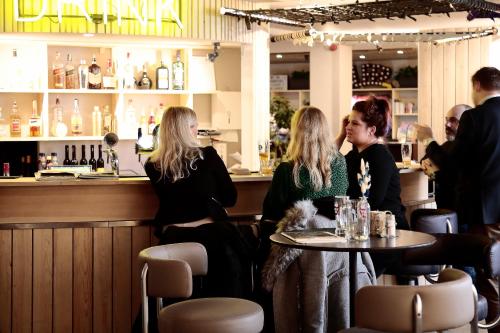 a group of women sitting at a table in a bar at Maverick Central Market in Budapest