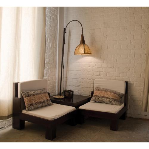 a room with two chairs and a table with a lamp at Vanaashrya Resort and Spa Sariska in Tehla