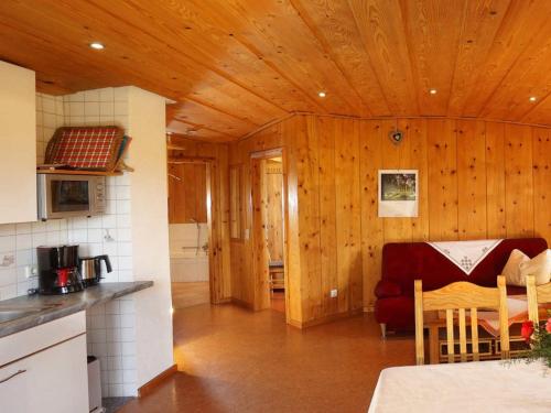 a kitchen with wooden walls and a table in a room at Hinterbauer Hof in Oberharmersbach