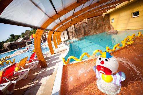 a pool at a resort with a water park at Camping Club Le Littoral - Maeva in Argelès-sur-Mer