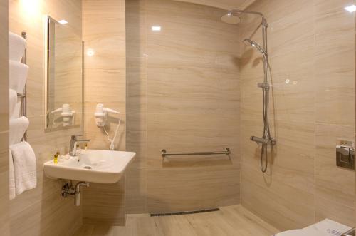 y baño con lavabo y ducha. en Hotel Star, en Mukácheve