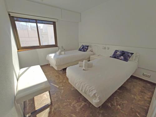 a living room with two beds and a couch at Sunny apartment with fantastic terrace views! in Valencia