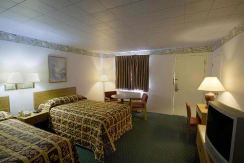 Habitación de hotel con 2 camas y escritorio en America's Best Value Inn Litchfield, en Litchfield