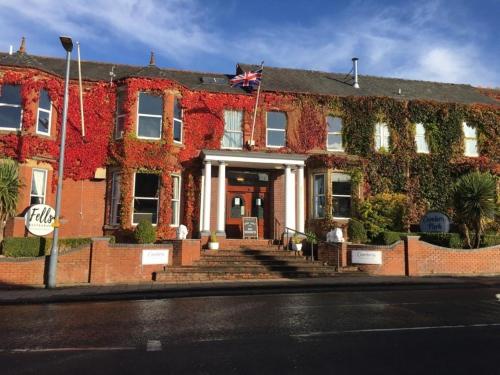 a red brick building with ivy on it at Cumbria Park Hotel in Carlisle