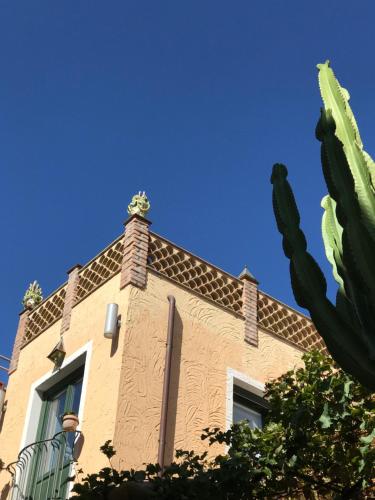 a building with a cactus in front of it at Torre Di Sebastiano in Gaggi