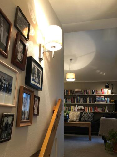 a hallway with a living room with photographs on the wall at Hotel Raudaskrida in Þóroddsstaður