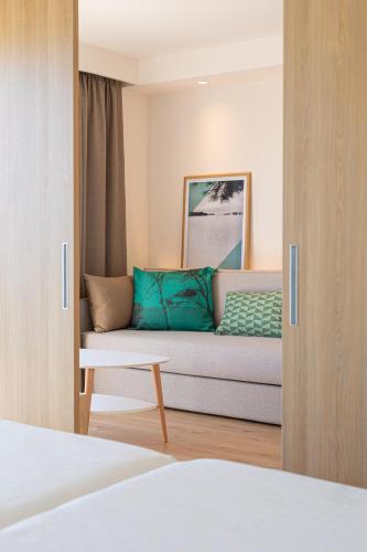 a living room with a couch in a room at JS Portocolom Suites in Portocolom