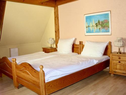 a bedroom with a wooden bed with two night stands at Hotel Alt Ebingen in Albstadt