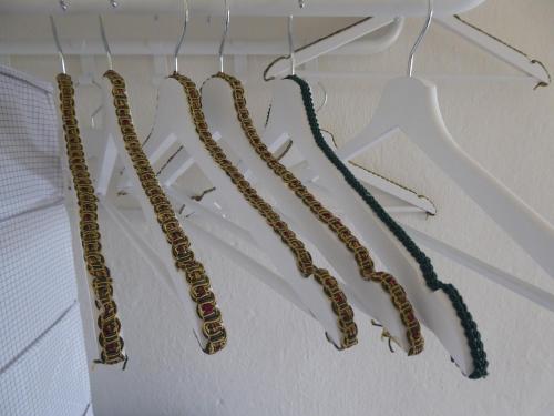 a group of gold chains hanging on a wall at La Vite è Bella in Govone