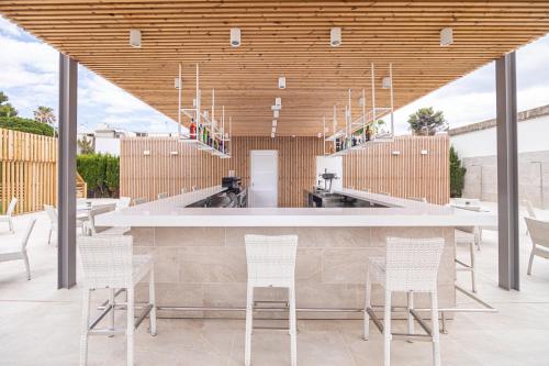 a large room with a lot of tables and chairs at JS Portocolom Suites in Portocolom