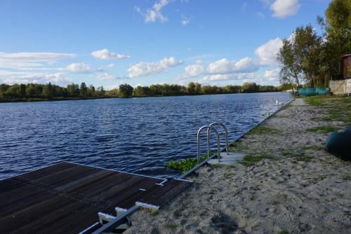 a dock on the side of a lake at Great accommodation for rest and relaxation! in Vishenki