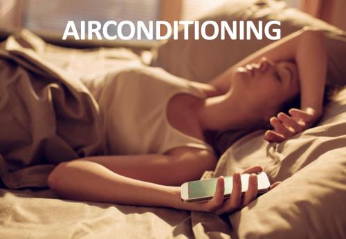 a woman laying on a bed holding a cell phone at Hotel & Aparthotel Casteau Resort Mons Soignies in Casteau