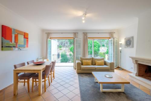 a living room with a couch and a table at D. Sebastião Townhouse in Casal da Lagoa Seca