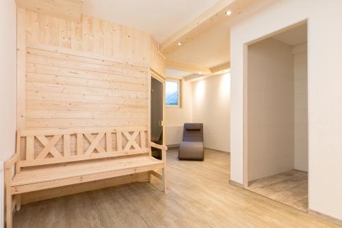 a room with a wooden wall and a bench at Apart&Chalet Chiara in Neustift im Stubaital