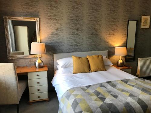 a bedroom with a bed and a lamp at Rooms @ Number Six in Oakham