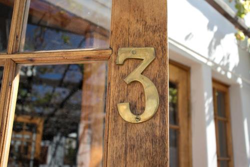 a wooden number on the door of a house at Die Herehuis in Beaufort West