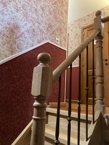 a set of stairs with a red wall at Le Papillon d'Or in Arlon