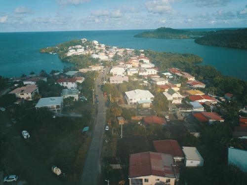 an aerial view of a town next to the water at Appartement de la Baie in Le Vauclin