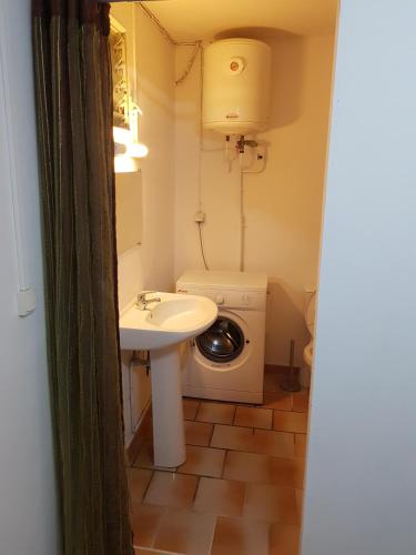 a small bathroom with a sink and a toilet at Appartement de la Baie in Le Vauclin