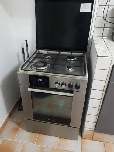 a kitchen with a stove in a room at Appartement de la Baie in Le Vauclin