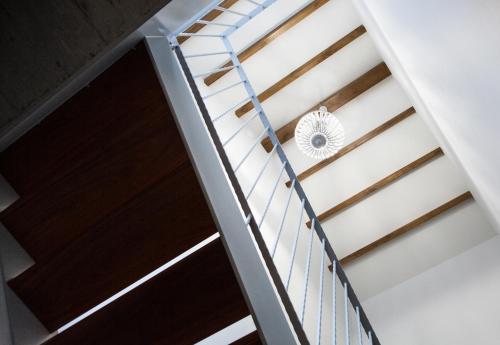 a staircase in a house with a metal railing at Eira Gundián in Vedra