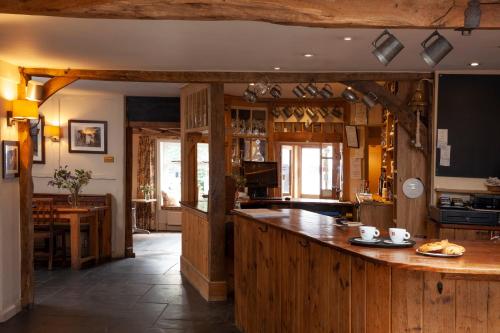 a large kitchen with a large wooden counter top at The Angel Inn, Petworth in Petworth