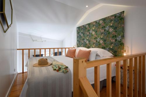 a bedroom with a bed with a hat on it at Alfama Yellow House in Lisbon