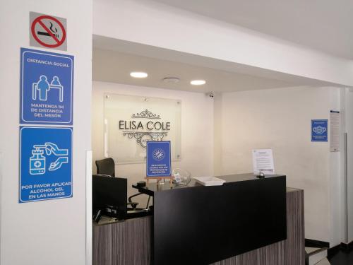 an office with a desk and signs on the wall at Hotel Elisa Cole in Santiago