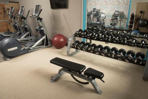 a gym with a bunch of exercise equipment at Crowne Plaza Fredericton Lord Beaverbrook by IHG in Fredericton
