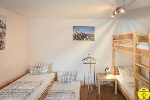 a bedroom with two bunk beds and a ladder at Ferienwohnung beim Europa-Park Rust in Rust