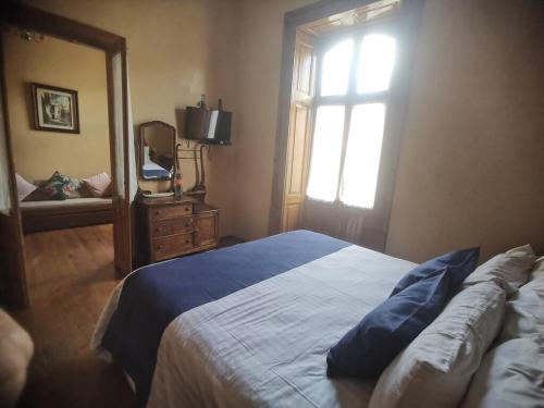 a bedroom with a bed and a window and a mirror at Hotel Boutique Casa de las Manrique in Guanajuato