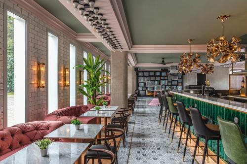 a restaurant with tables and chairs and a bar at The ReMIX Hotel in Paris