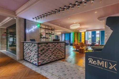 a lobby of a hotel with a reception desk at The ReMIX Hotel in Paris