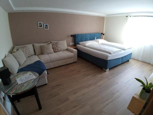 a living room with a couch and a bed at CHILL&SLEEP Bad Ischl in Bad Ischl