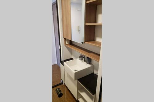 a bathroom with a sink and a cabinet at Monoambiente de Lujo en Equipetrol - You in Santa Cruz de la Sierra