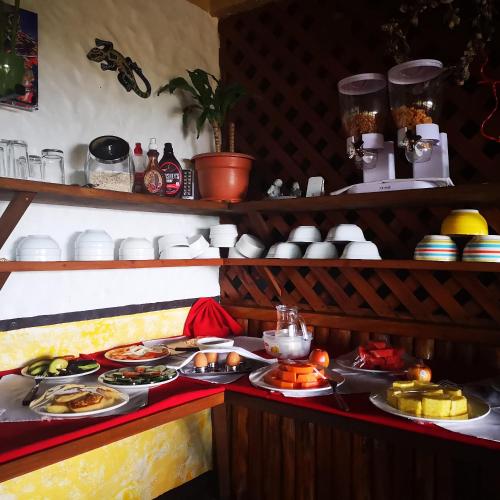 a buffet with plates of food on a table at Hotel Belvedere Playa Samara Costa Rica in Sámara