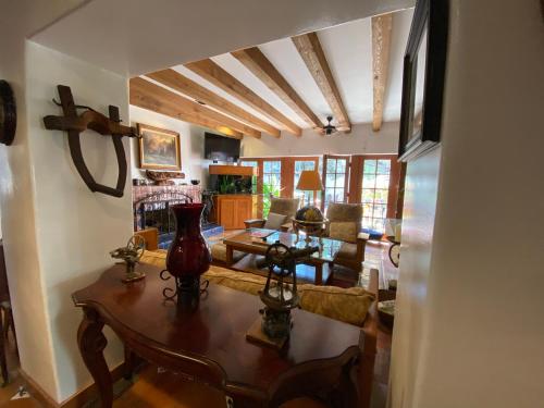 a living room with a table and a couch at Villa Rosa Inn in Santa Barbara