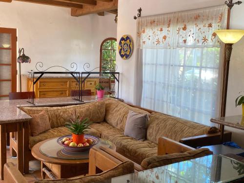 a living room with a couch and a table at Villa Rosa Inn in Santa Barbara