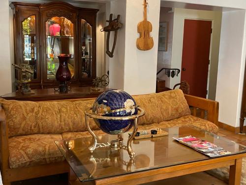 a living room with a couch and a glass table at Villa Rosa Inn in Santa Barbara